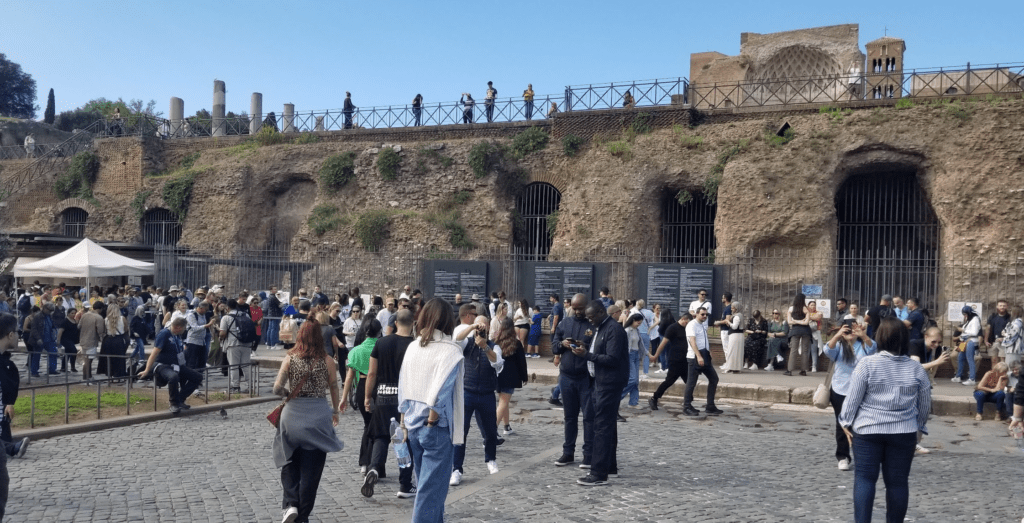 a group of people walking in a courtyard