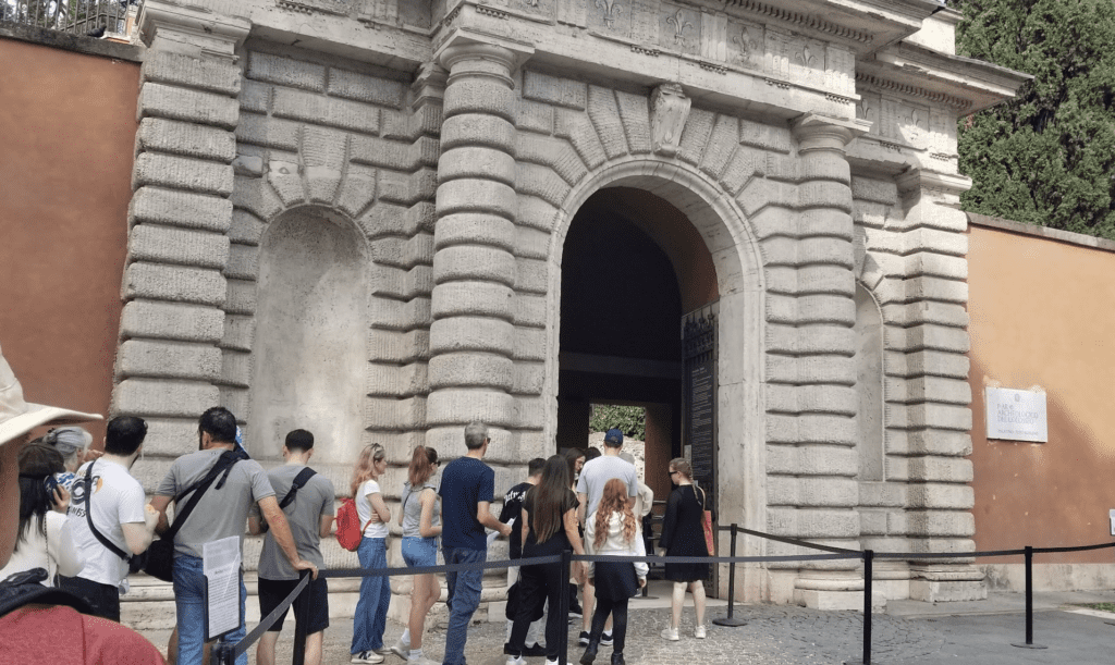 a group of people standing in front of a stone building