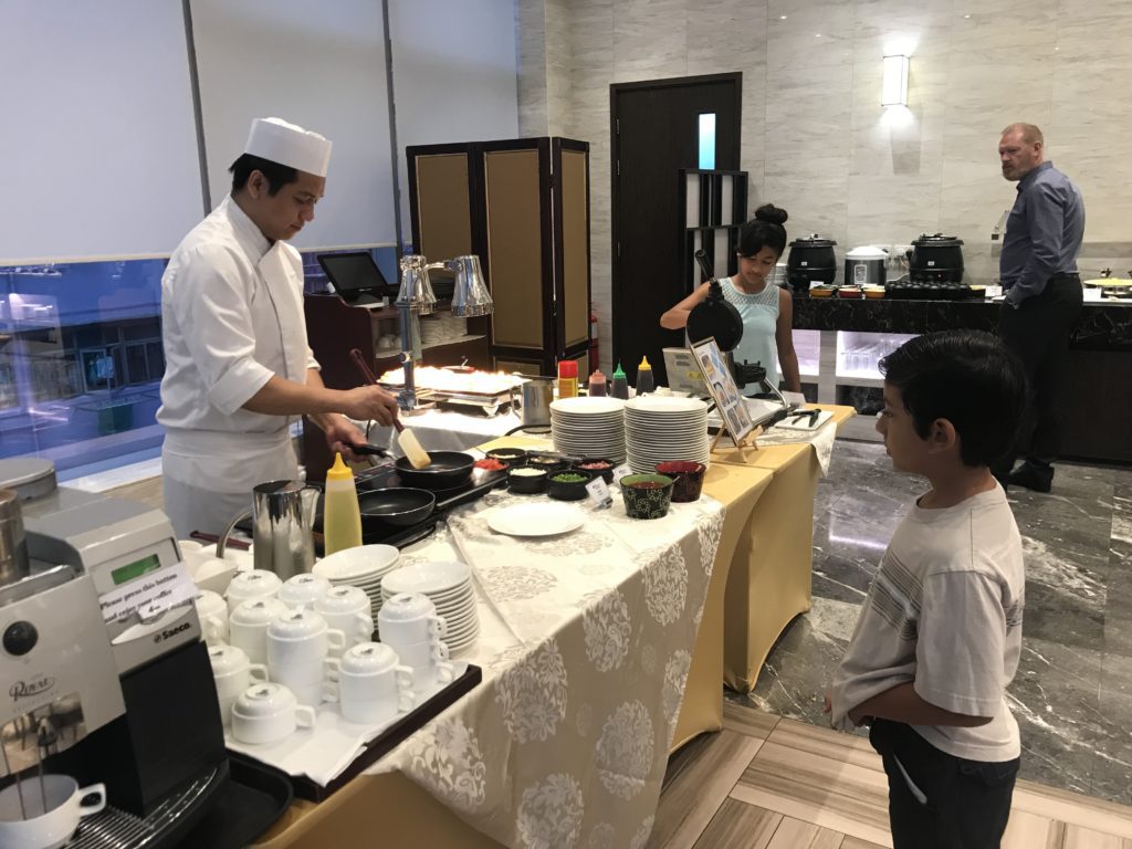 a man and boy cooking in a restaurant