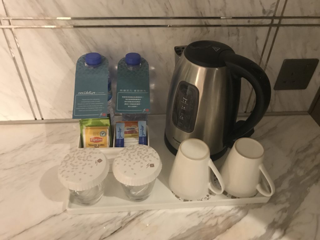 a tray with a kettle and cups on it