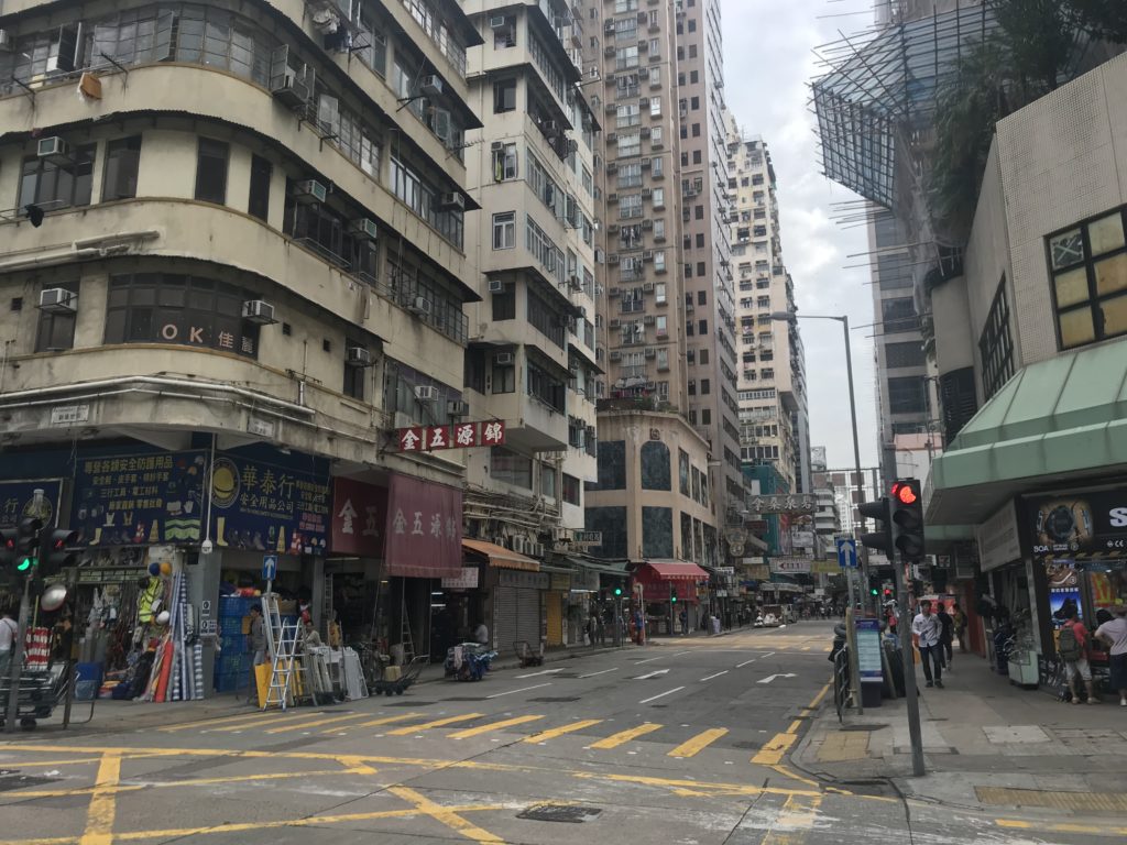 a street with buildings and people walking on it