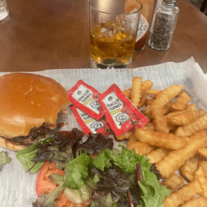 a burger and fries on a table