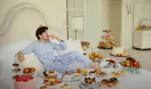 a man sitting on a couch eating food