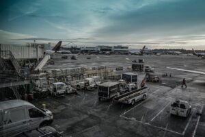 a airport with vehicles parked on the ground