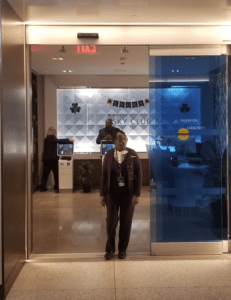 a woman standing in front of a glass door