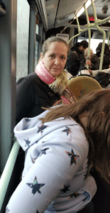 a woman in a pink scarf on a bus