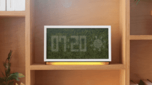 a digital clock on a shelf