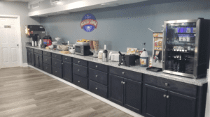 a kitchen with black cabinets and black counter tops