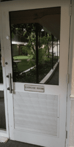 a door with a glass door and a green lawn