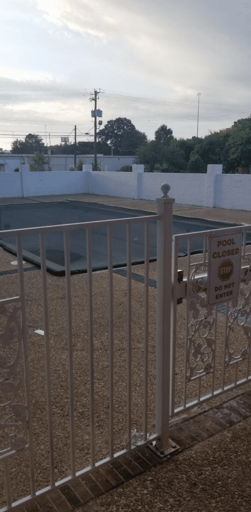 a pool with a gate and a fence