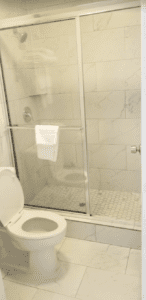 a bathroom with a glass shower door