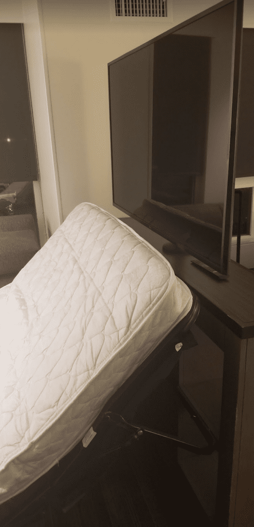 a mattress next to a television