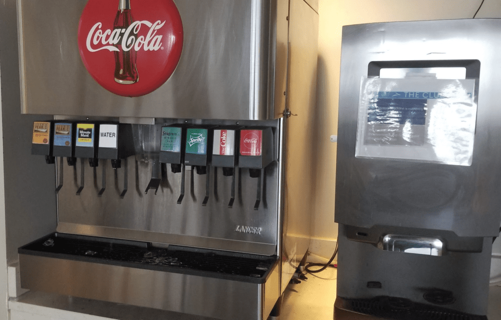 a soda machine with a red circle and a red circle with a red circle on it