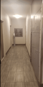 a hallway with lockers and a picture on the wall