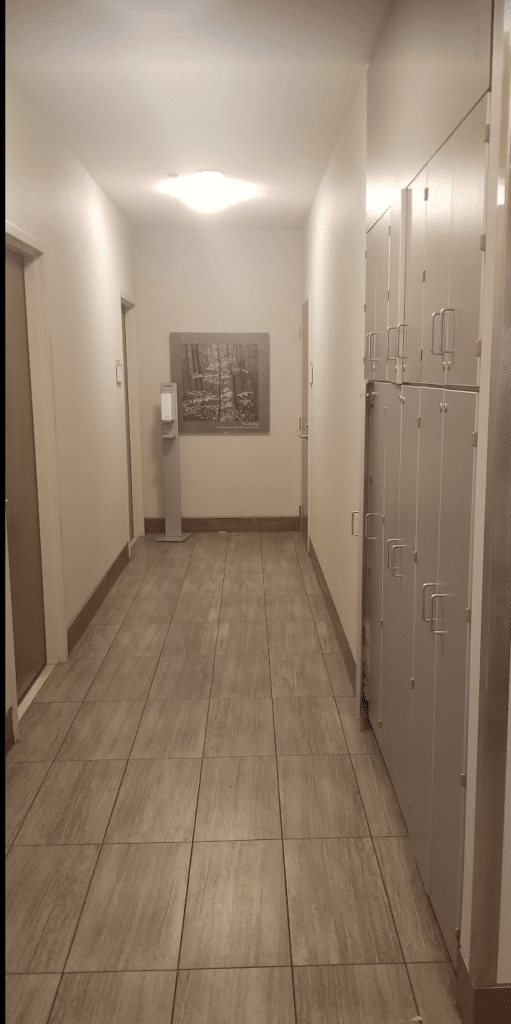 a hallway with lockers and a picture on the wall