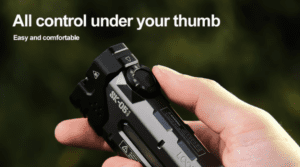 a hand holding a black gun