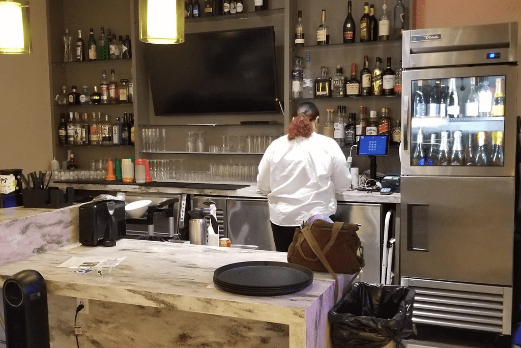 a woman standing at a bar