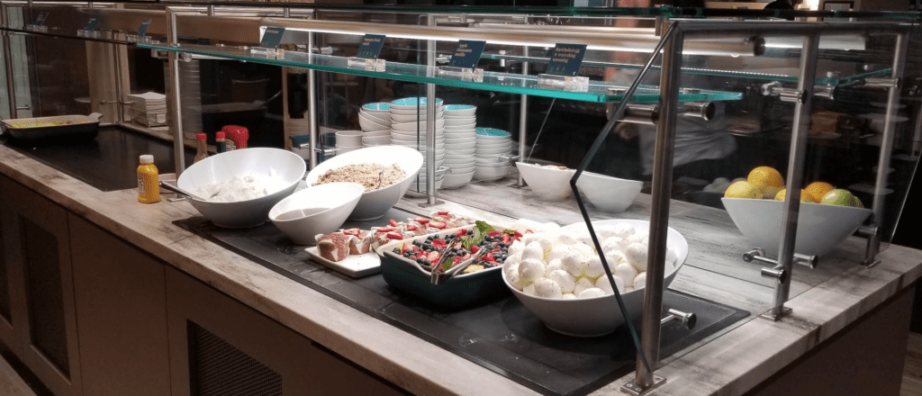 a display case with bowls of food