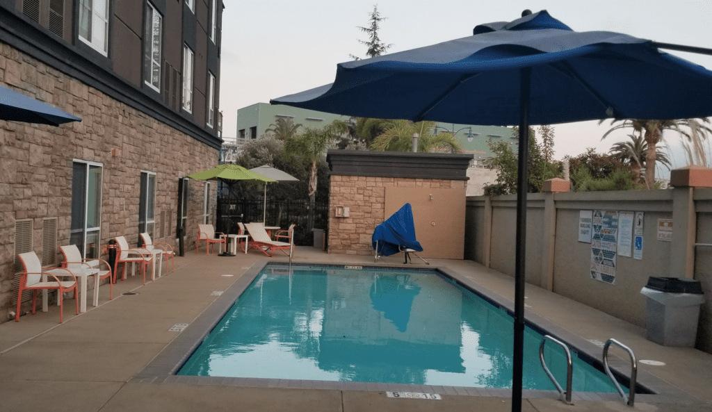 a pool with umbrellas and chairs