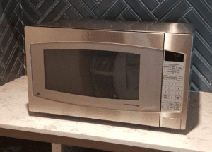 a silver microwave on a counter