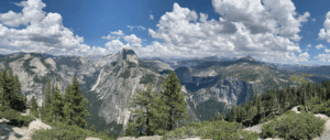 a mountain range with trees and a valley