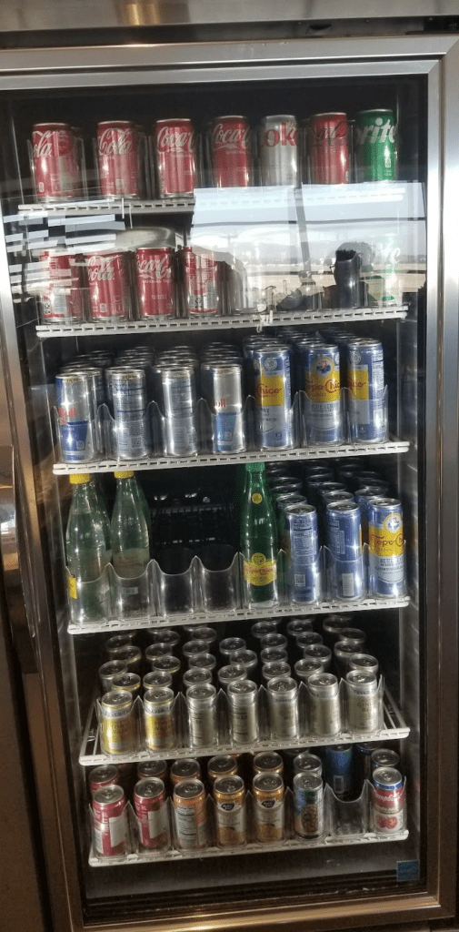 a refrigerator full of cans and glasses