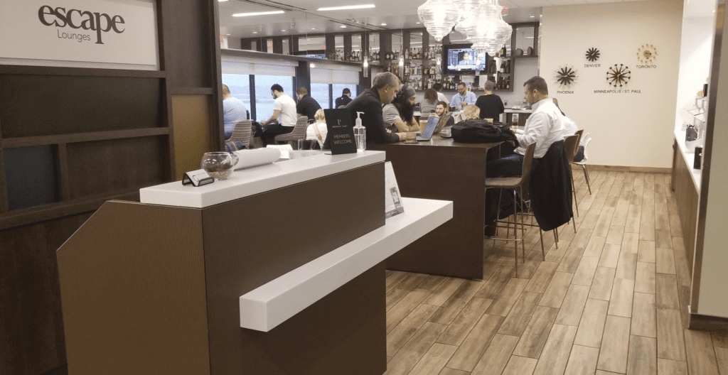 a group of people sitting at tables in a room with a wood floor