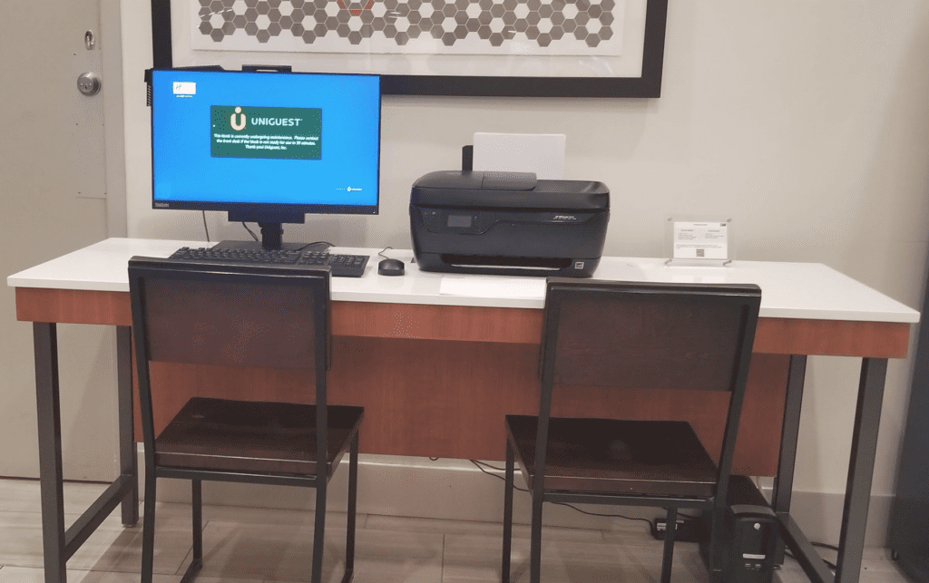 a computer on a desk with a printer and a printer