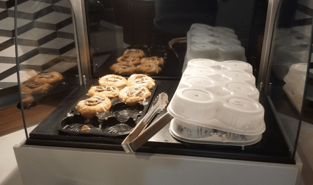 a trays of pastries and a tray of muffins