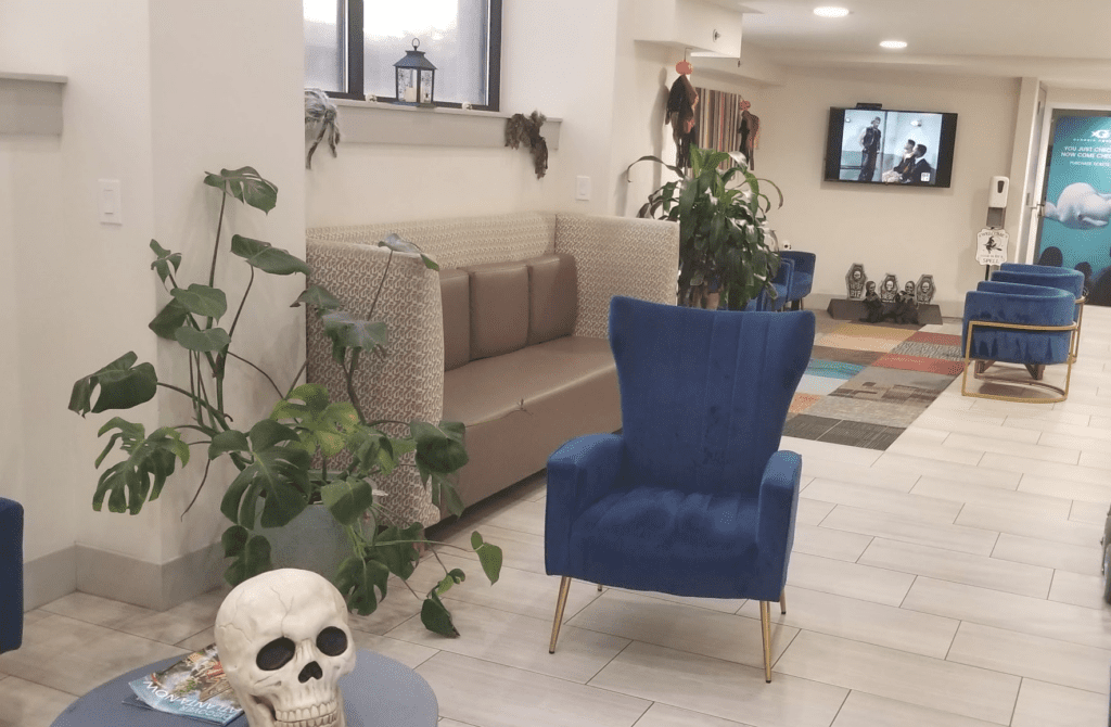 a room with a blue chair and a skull