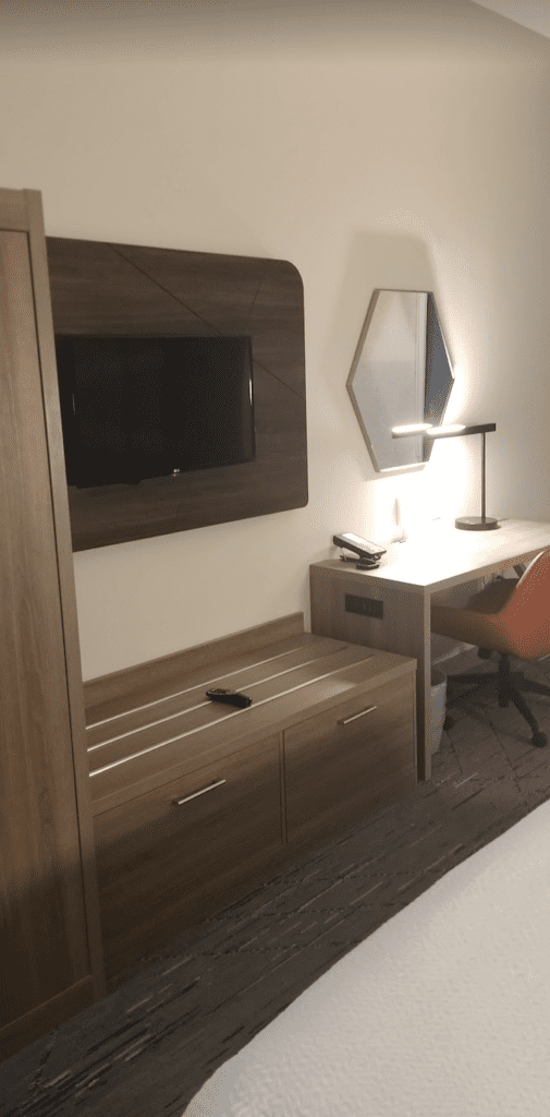 a desk and a television on the wall