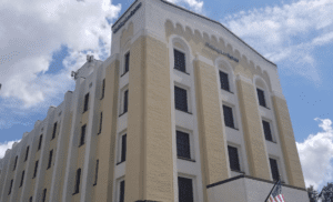 a building with a blue sky and clouds