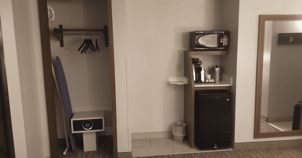 a room with a microwave and a refrigerator