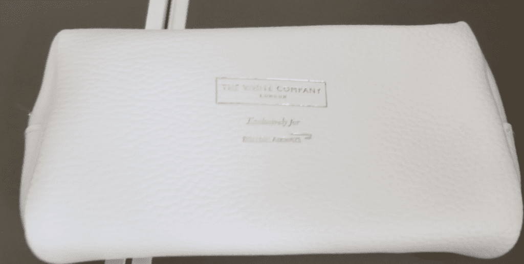 a white leather wallet with silver text