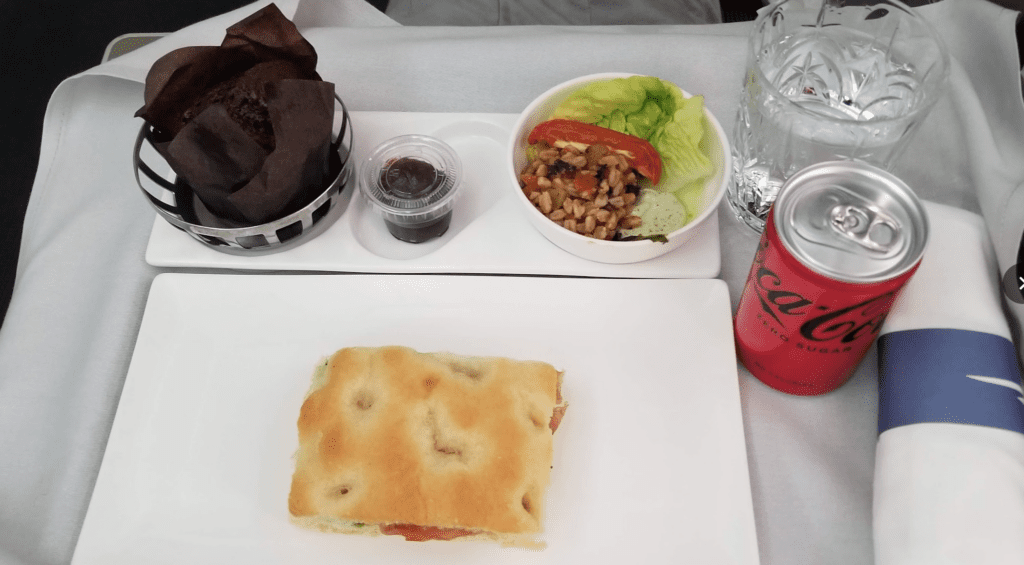 a plate of food and a drink on a tray