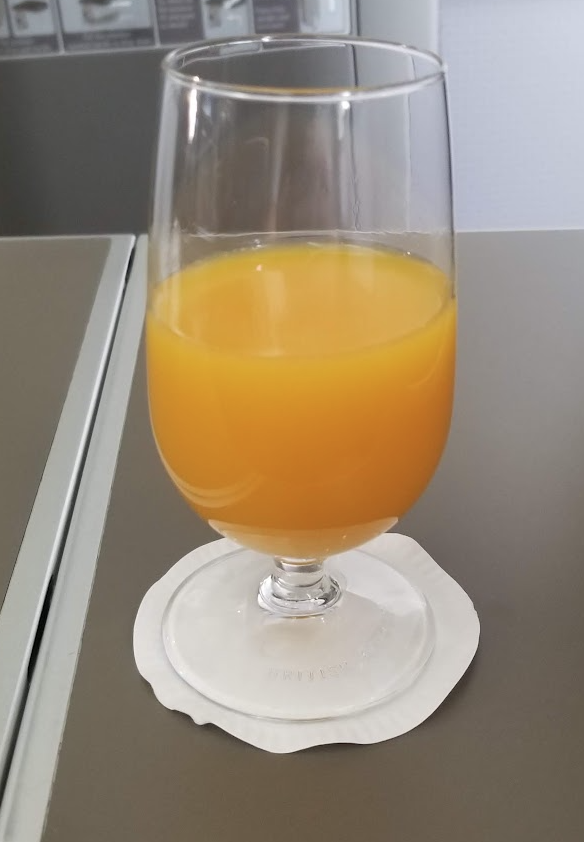 a glass of orange juice on a table