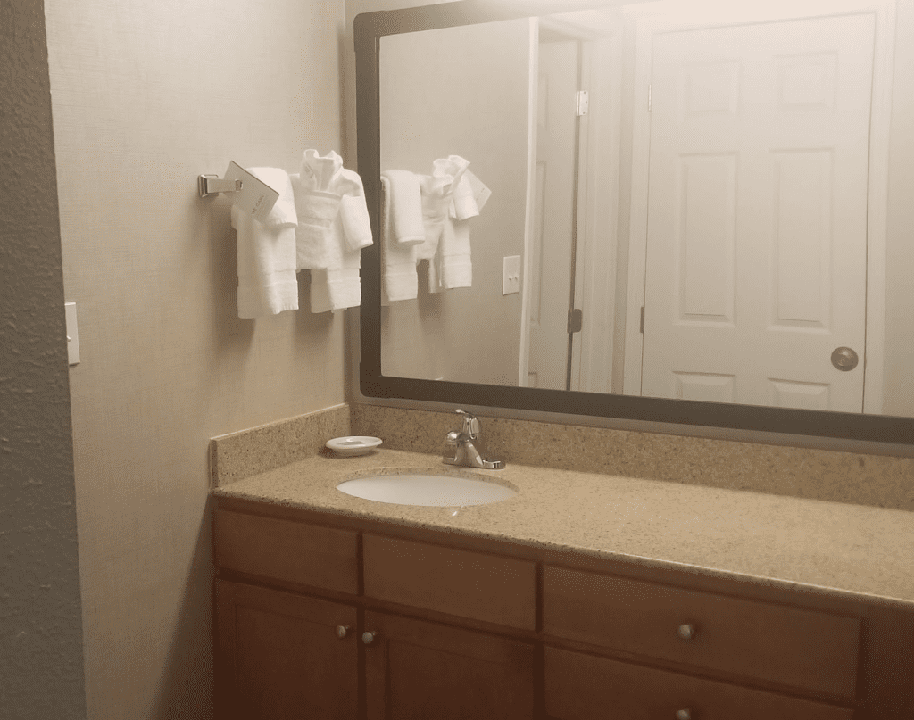 a bathroom with a mirror and sink